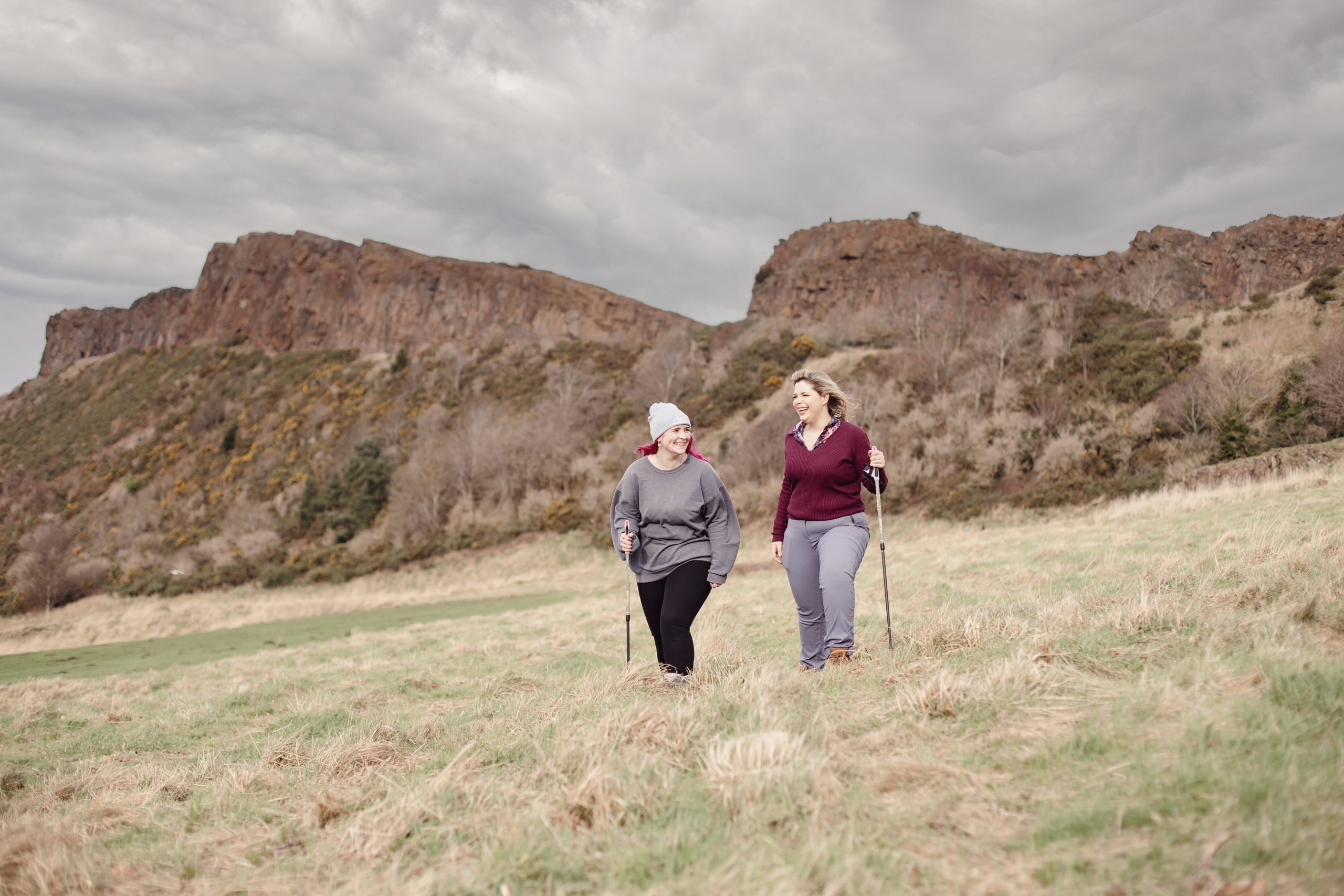 two ladies walk in the hills laughing