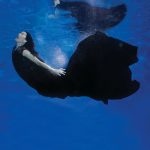 lady in a black ball gown swimming underwater
