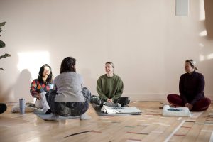 yoga teacher chats to students