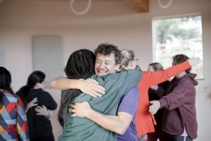 connection during yoga retreat, hugging