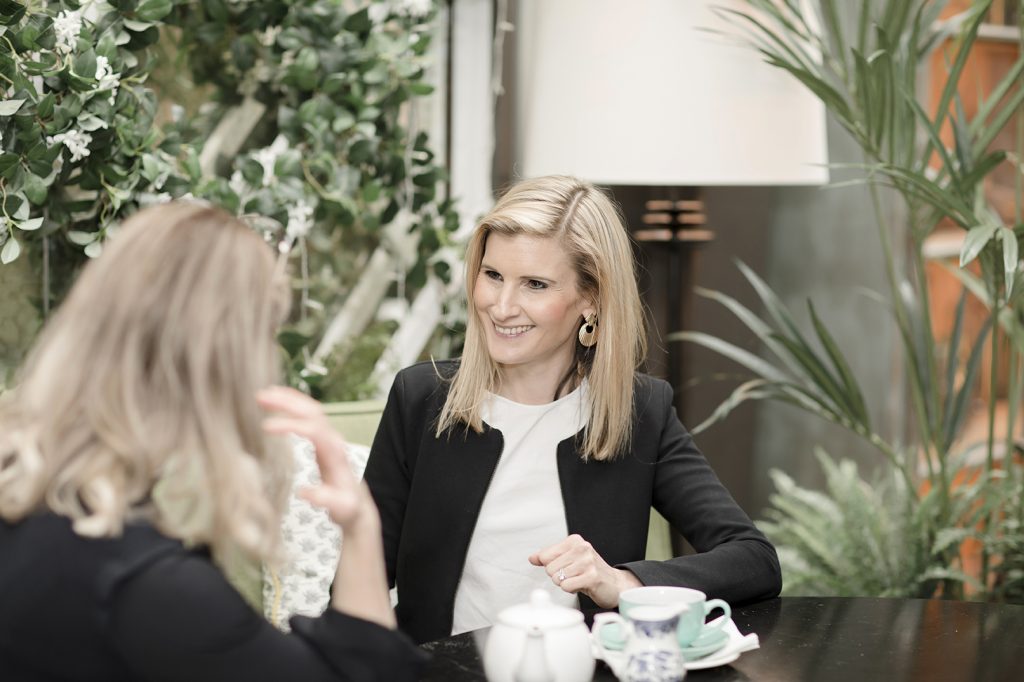image shows two women having a relaxed informal business meeting